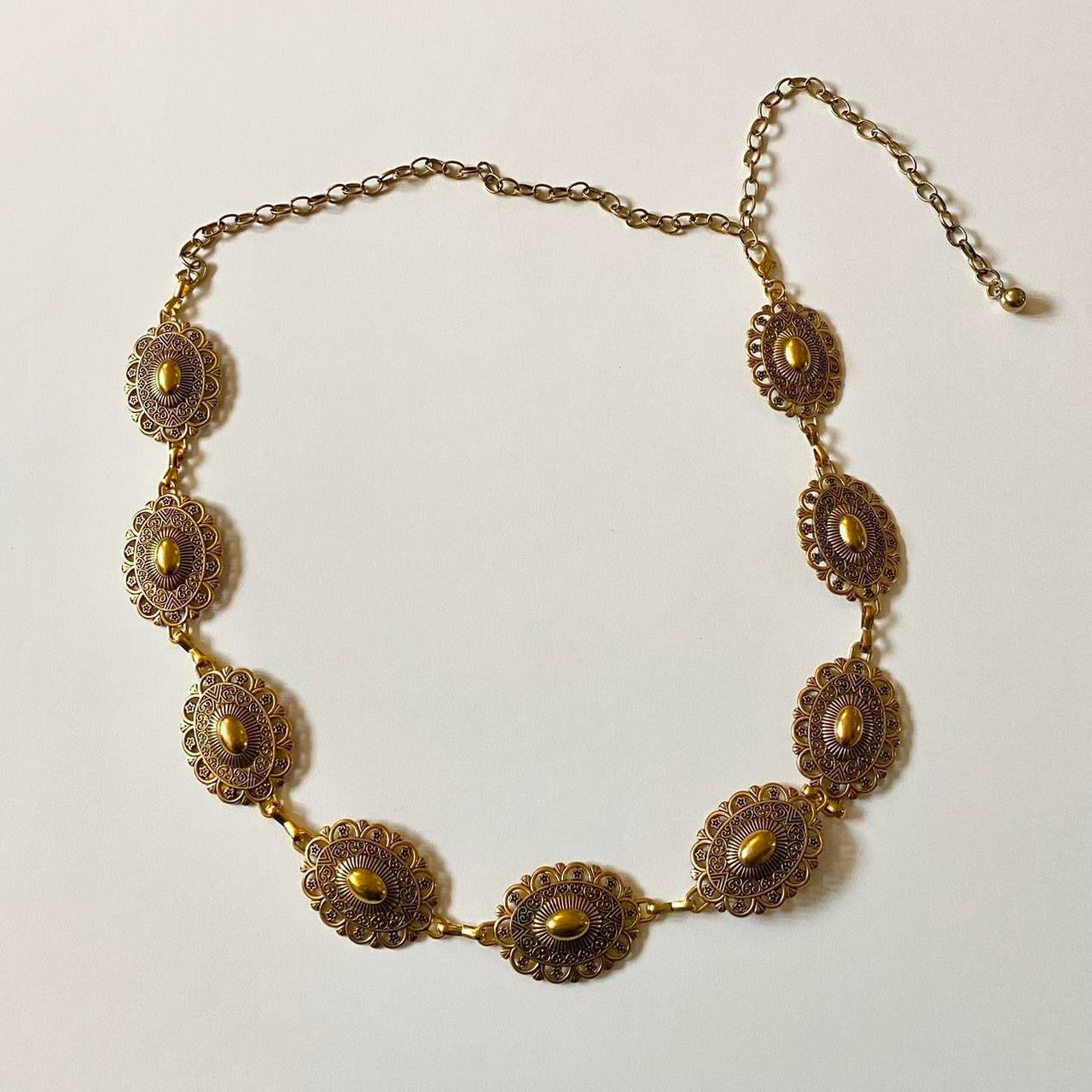 Gold coloured vintage chain belt with circular design. Adjustable!