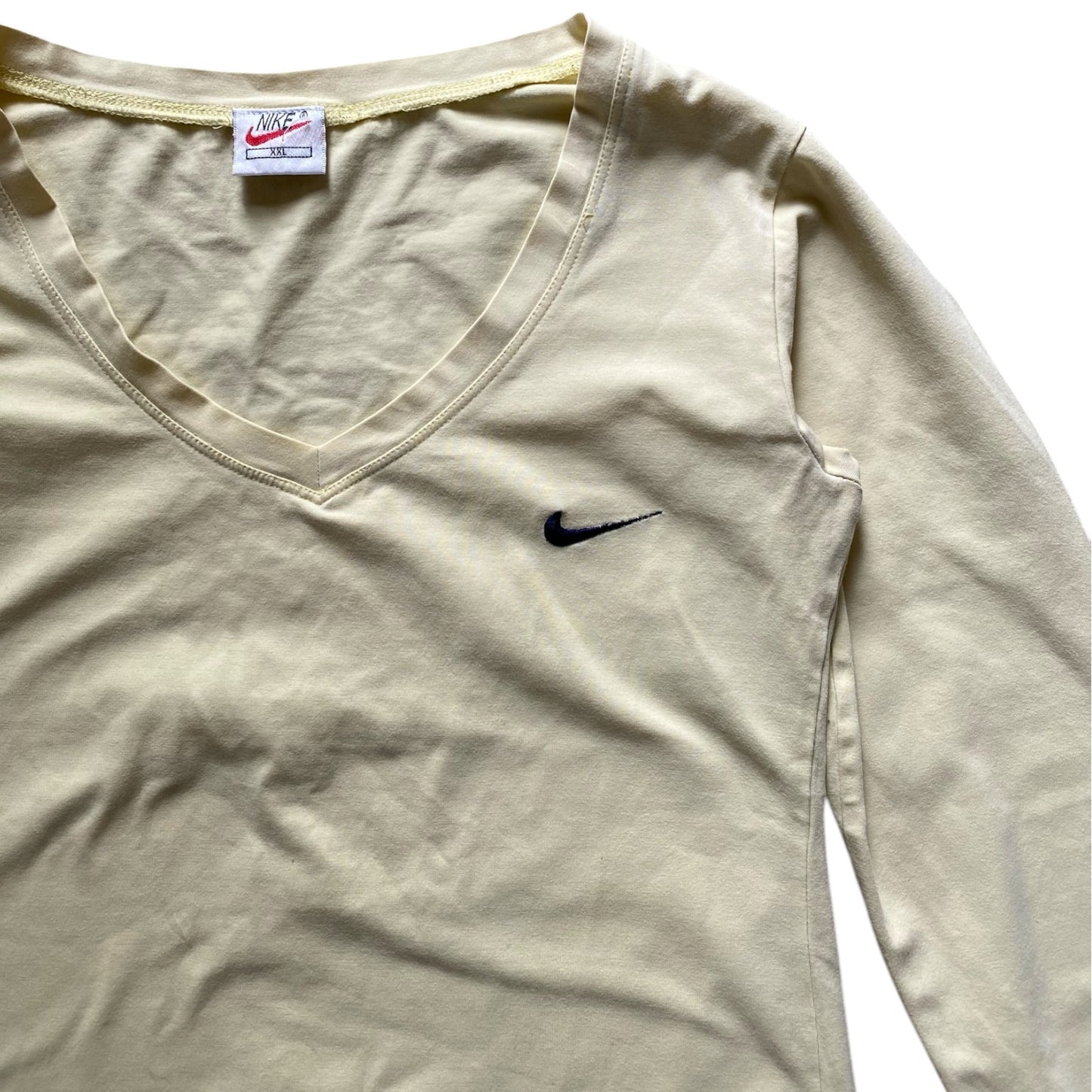 Vintage Nike pale yellow long sleeved top. Some tiny holes in one sleeve. Not noticeable on. Size S/8-10.