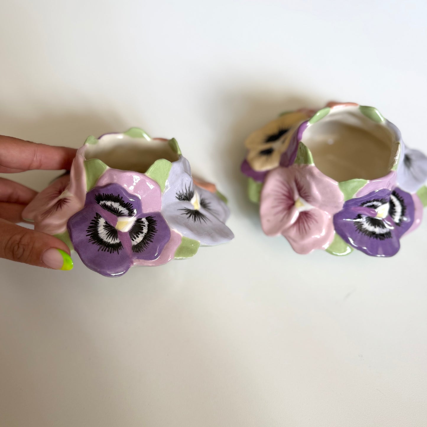 Vintage ceramic homemade pansy pots/ candle holders. One has a small chip as shown.
