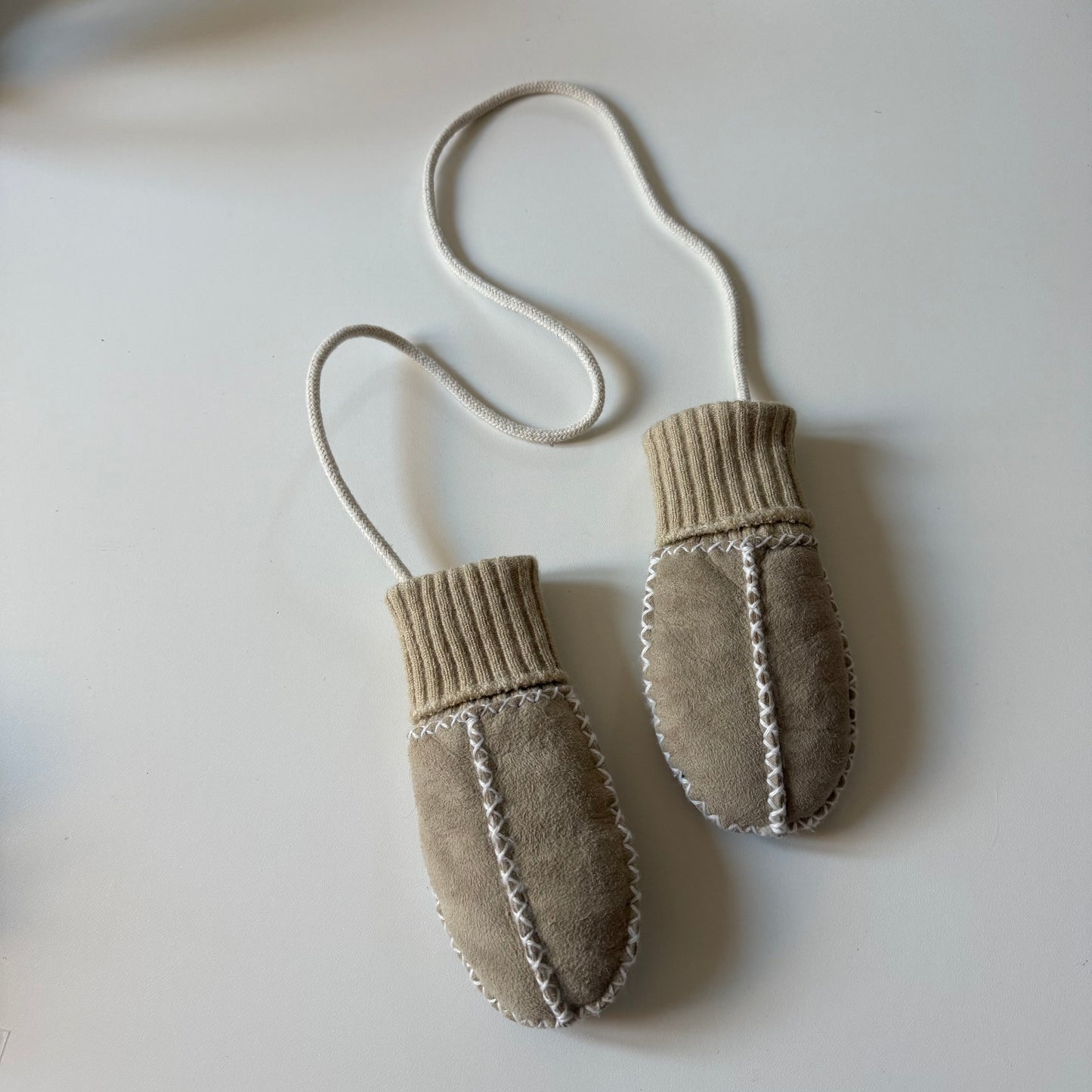 Vintage baby sheepskin mittens on a string. Size approx 6-12 months.